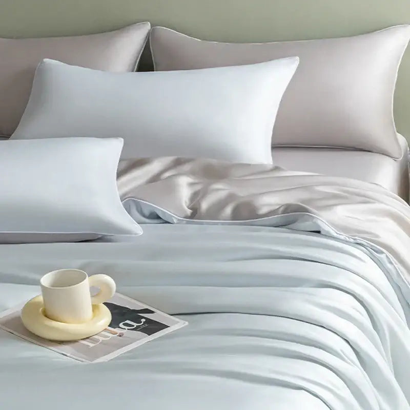 Light blue satin bedding set with solid color duvet cover and matching pillowcases featuring decorbites cool touch