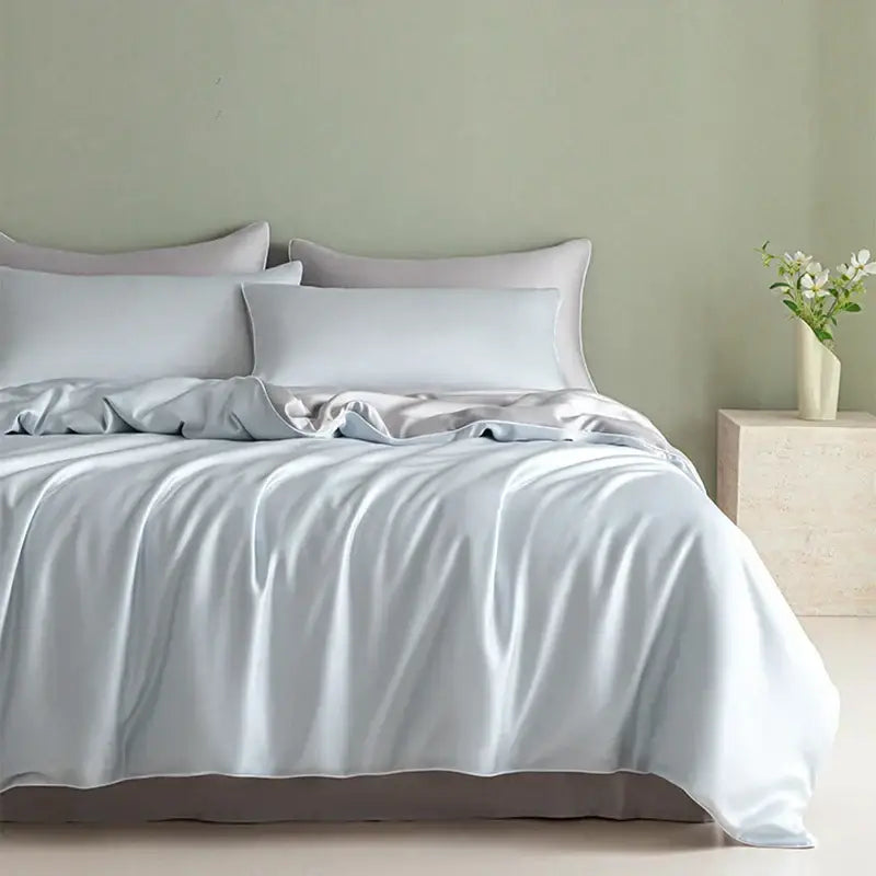 Light blue satin bedding set with solid color duvet cover and matching pillowcases featuring decorbites cool touch