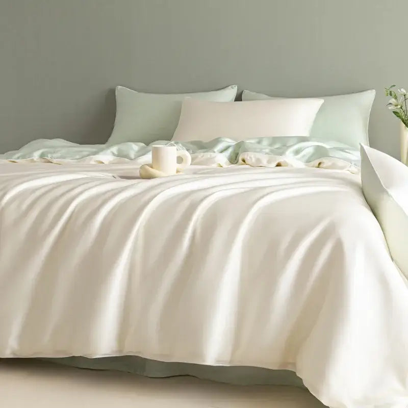 Cream-colored satin duvet cover with soft glossy finish and subtle sheen in a solid color bedding set decorbites cool touch