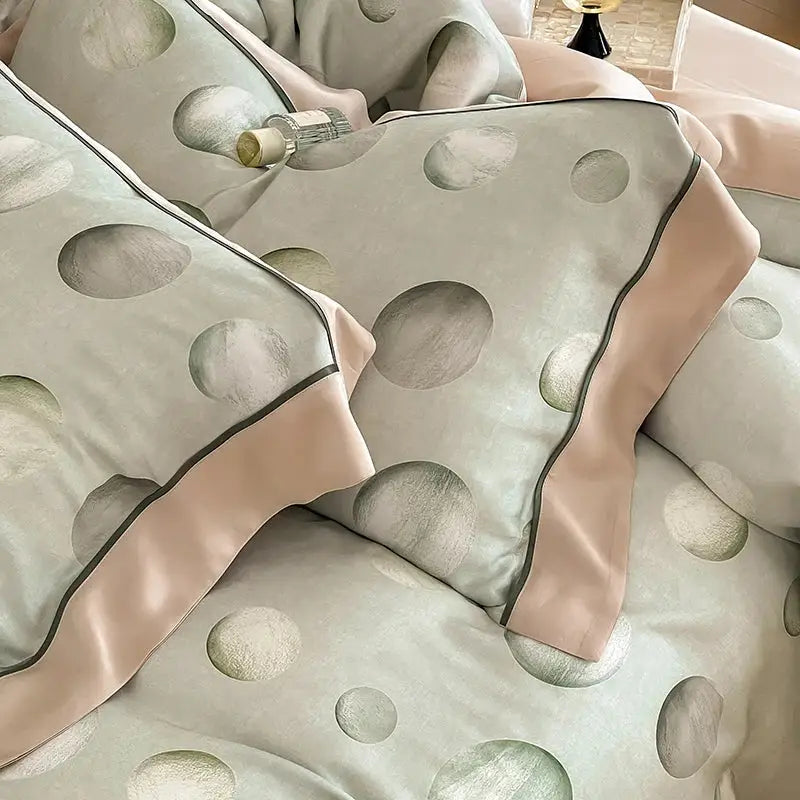 Light gray satin pillowcases with metallic silver patterns and blush pink piping in egyptian cotton bedding set