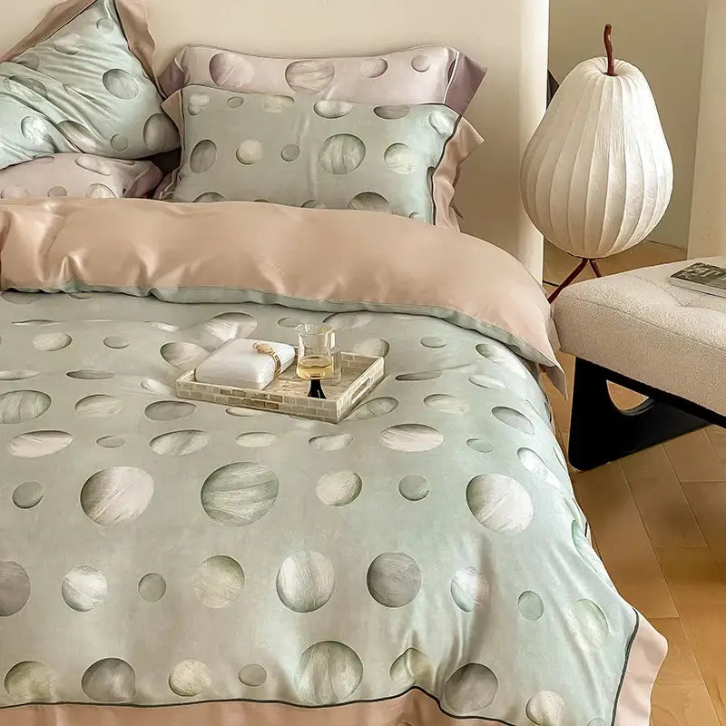 Pastel green satin duvet cover with subtle circular pattern and soft pink piping in egyptian cotton bedding set