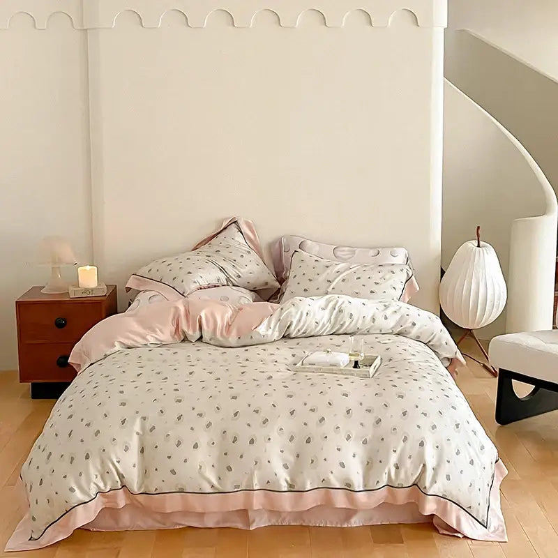 Pastel pink and cream satin cotton bedding set with gray leaf patterns in an egyptian cotton bedding bedroom collection