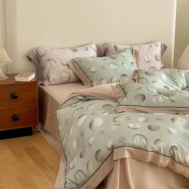 Pastel green and blush pink satin egyptian cotton bedding set with subtle circular dot pattern for bedroom use