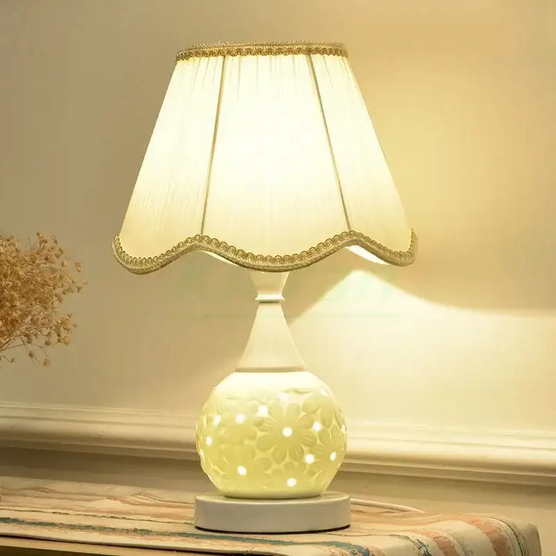 Scalloped cream ceramic led desk lamp with floral cutout design and gold-trimmed shade for bedroom decorbites ceramic led use