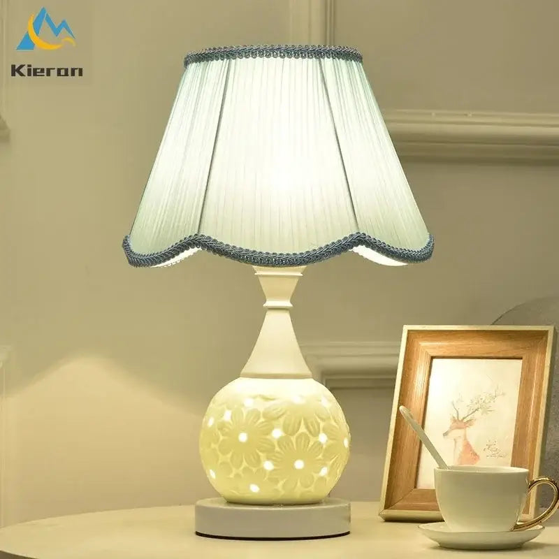 Cream-colored ceramic led desk lamp with scalloped light blue trim shade and floral cutout base for decorbites ceramic led