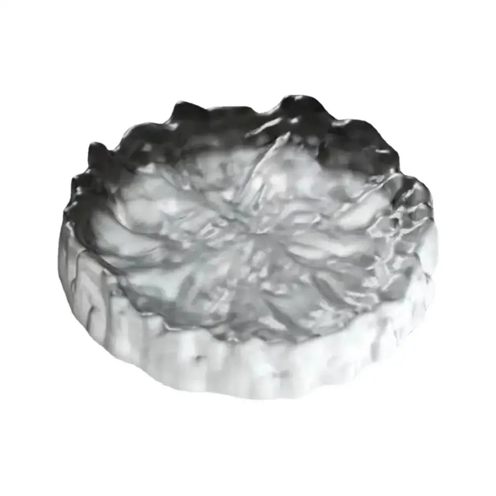 Silver metallic ashtray with textured leaf design and scalloped edges for crystal glass coaster and jewelry display panel