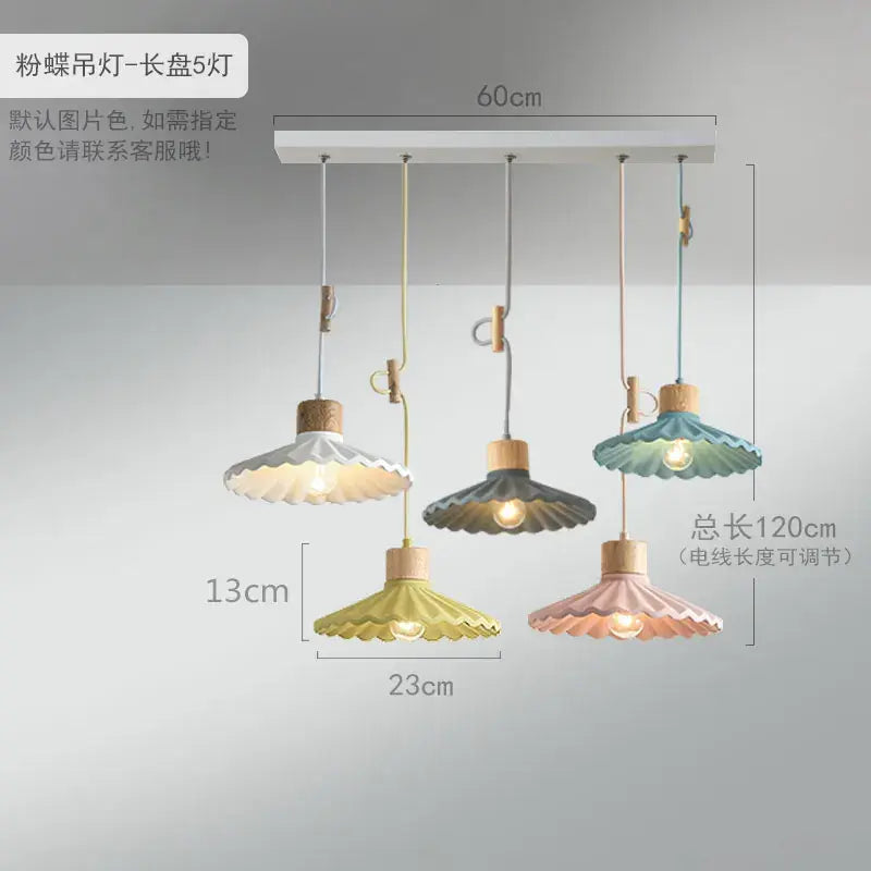 Scalloped pastel led pendant lights shaped like butterflies with wooden accents and adjustable cords for dining rooms