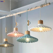 Scalloped pastel led pendant lights with wooden tops and fabric shades in pink teal and gray for dining room