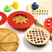Red silicone pie crust shield with scalloped edge used as crust shield for baked berry pie filling