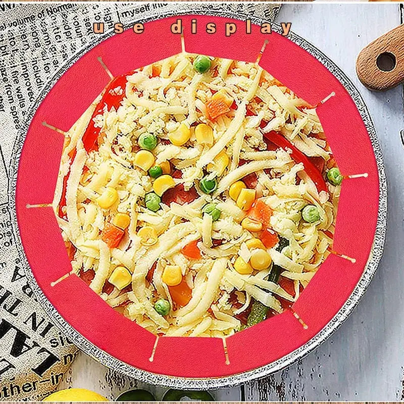 A vibrant red scalloped silicone pie crust shield with a silver rim holding shredded cheese and mixed vegetables on a pizza pan