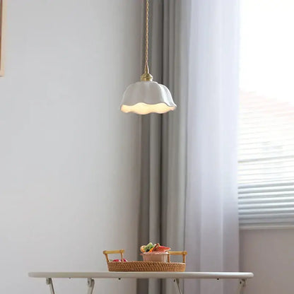 A scalloped white ceramic led pendant lamp with brass socket and gold-toned chain suspension for dining room decorbites ceramic led