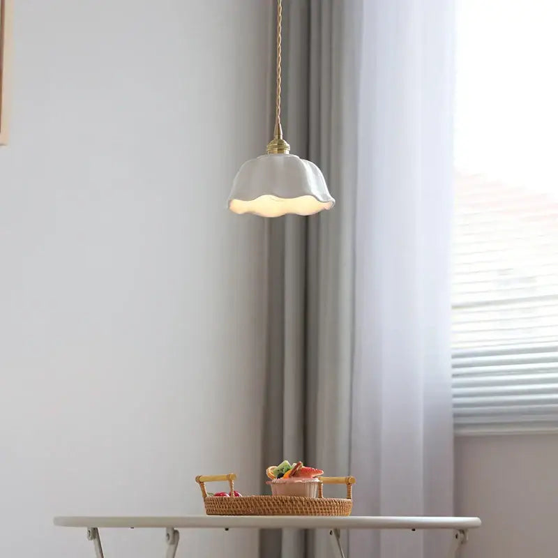 A scalloped white ceramic led pendant lamp with brass socket and gold-toned chain suspension for dining room decorbites ceramic led