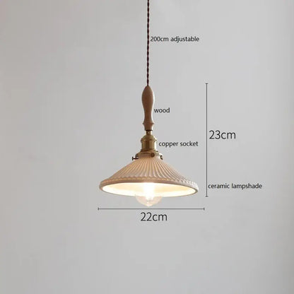 A warm-toned ceramic led pendant light with scalloped ribbed design hanging from wood and copper for decorbites ceramic led