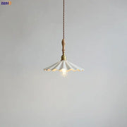 Scalloped white ceramic led pendant light with brass fixture and wooden handle hanging from braided cord decorbites ceramic led pendant
