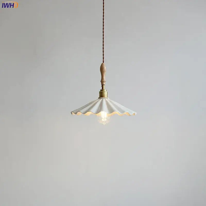 Scalloped white ceramic led pendant light with brass fixture and wooden handle hanging from braided cord decorbites ceramic led pendant