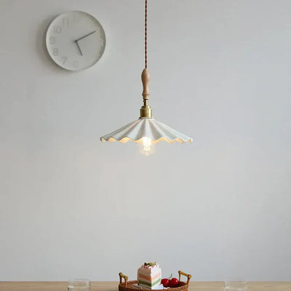 White scalloped ceramic led pendant light with wooden handle and brass accents from decorbites ceramic led pendant collection