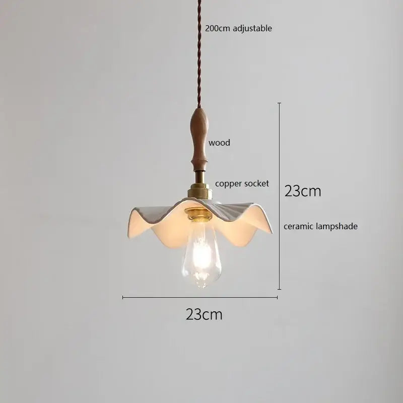 Scalloped white ceramic led pendant light with wavy petal design hanging from wooden handle copper socket