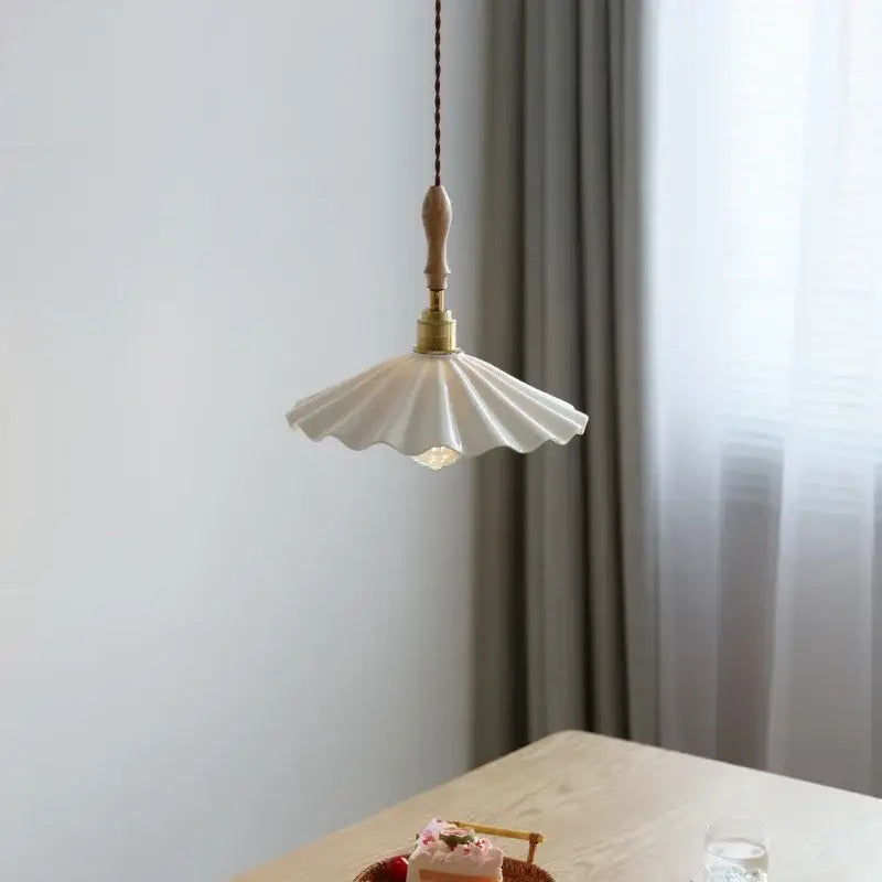 Scalloped white ceramic led pendant light with fluted fan-shaped shade and brass fixture by decorbites ceramic led