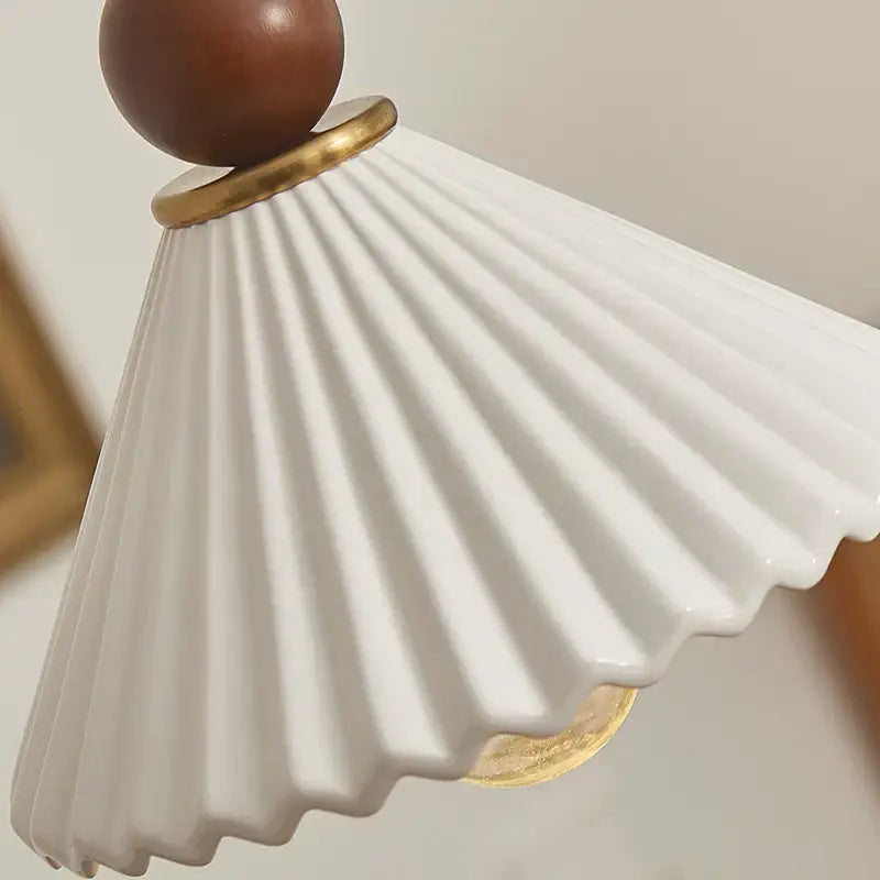 Scalloped white ceramic wood pendant lamp with fluted design and gold-toned accents for dining room decorbites ceramic wood led