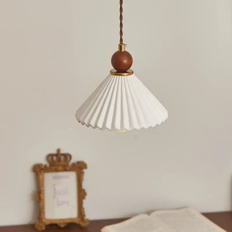 Scalloped white ceramic wood pendant lamp with pleated design brown wooden sphere and brass accents for dining room decorbites ceramic wood led