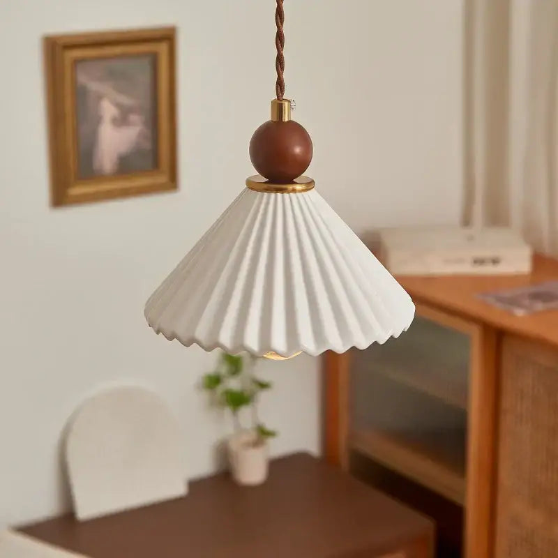 Scalloped white ceramic wood pendant lamp with pleated design brass accents and brown wooden sphere for dining room decorbites ceramic wood led