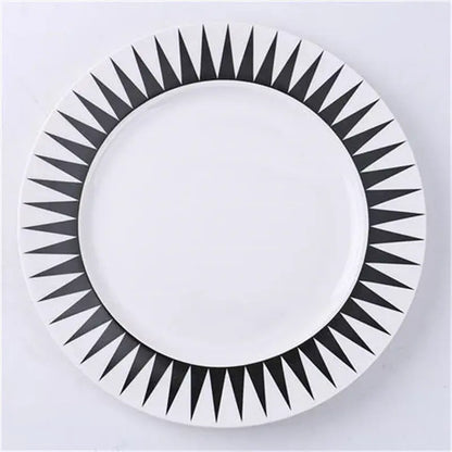 White ceramic dessert plate with bold black geometric sunburst pattern rim decorbites ceramic dessert plates