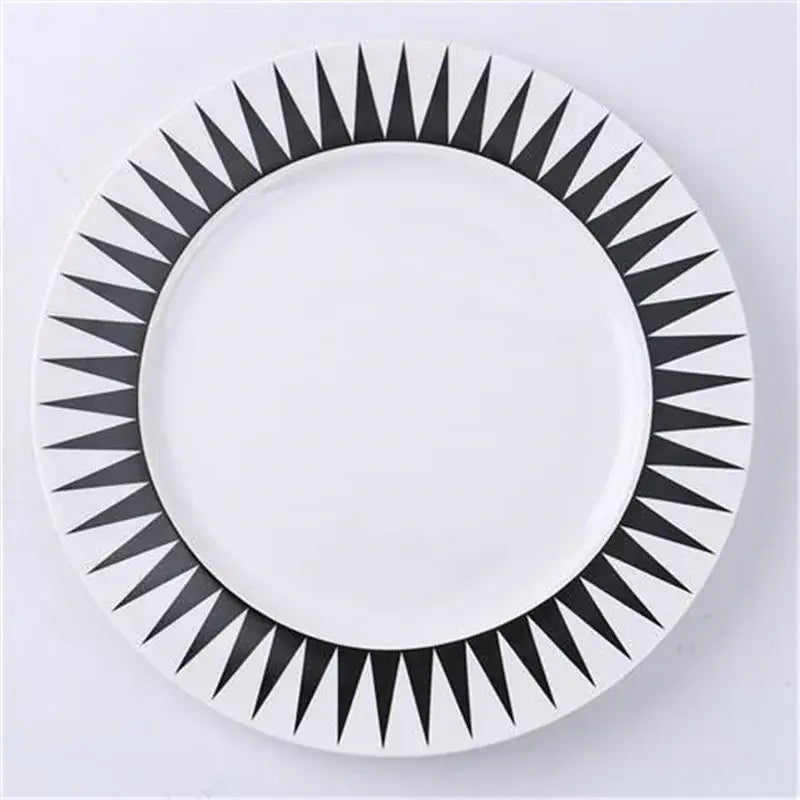 White ceramic dessert plate with bold black geometric sunburst pattern rim decorbites ceramic dessert plates