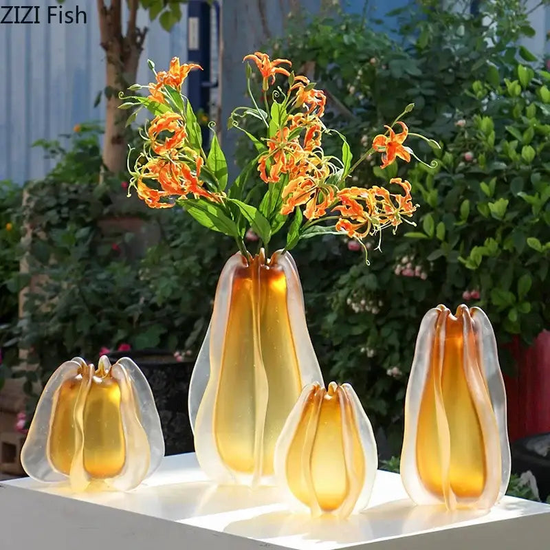 Sculpted translucent amber glass vase with a pear-shaped petal design decorates living room with decorbites carambola glass