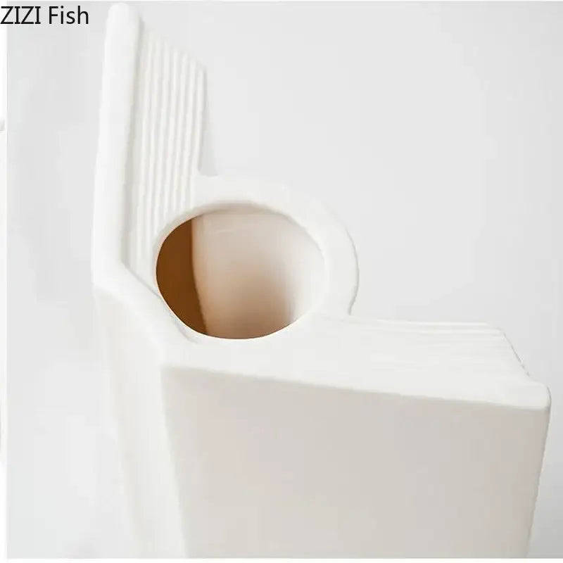 White ceramic fish-shaped wall-mounted toilet paper holder with circular opening and vertical ridges for decorbites creative flowers desk decoration