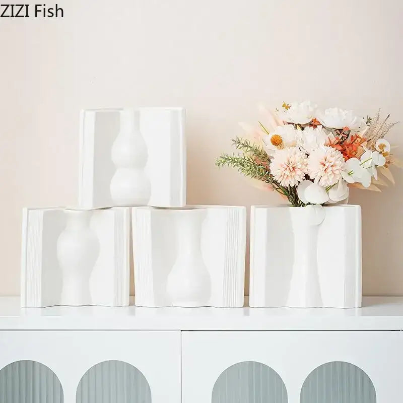 White ceramic vases with sculpted wavy contours and vertical ridged detailing for creative flowers desk decoration