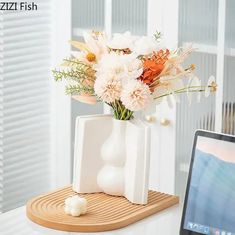 White ceramic vase with modern sculptural design featuring rounded bulbs and angular sides for flowers desk decoration