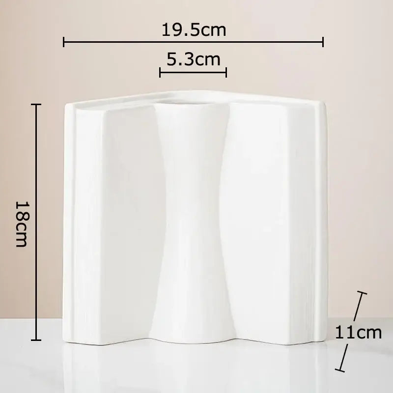 White ceramic vase with sculptural design and three flowing sections for creative flowers desk decoration by decorbites