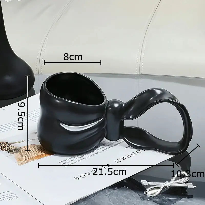 Black sculpted bowknot ceramic coffee mug with glossy finish and white accent stripe for kitchen tea use decorbites bowknot ceramic