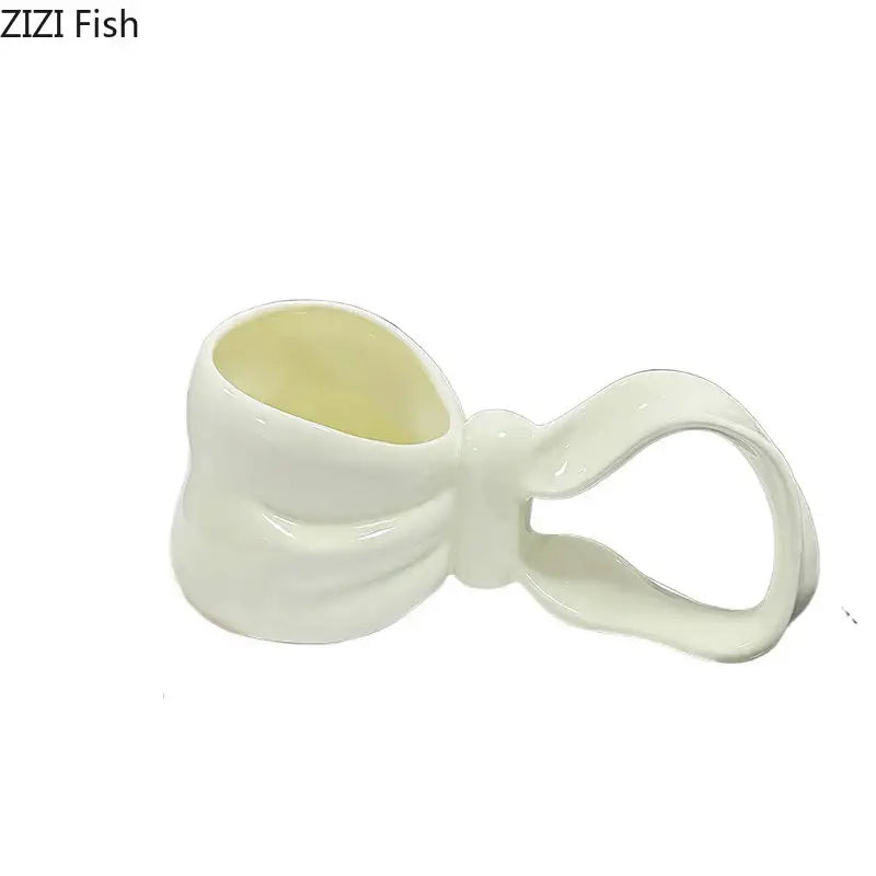 White ceramic decorbites bowknot ceramic coffee mug with glossy finish and cream-colored interior for kitchen tea use