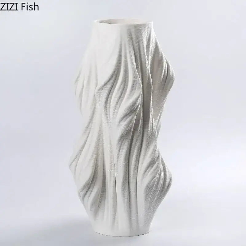 Sculpted white ceramic vase with flowing ribbed contours and purple flowers for bedroom decor decorbites ceramic vase