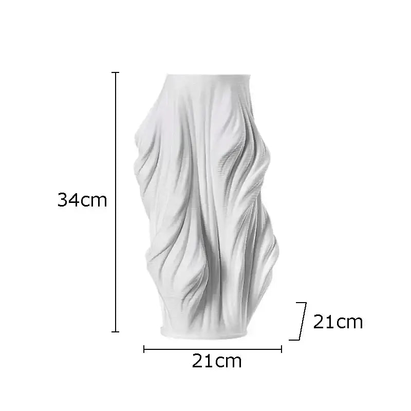A tall white decorbites ceramic vase with a sculpted flowing design and purple flowers for bedroom decor