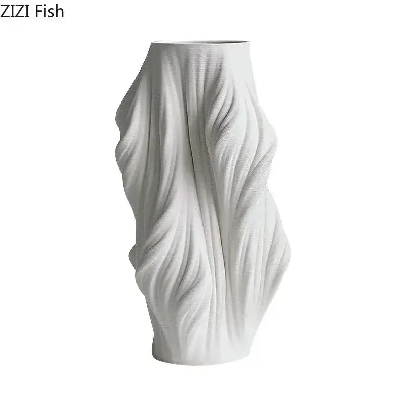 A sleek white decorbites ceramic vase with a sculpted flowing fabric design and purple flowers for bedroom decor