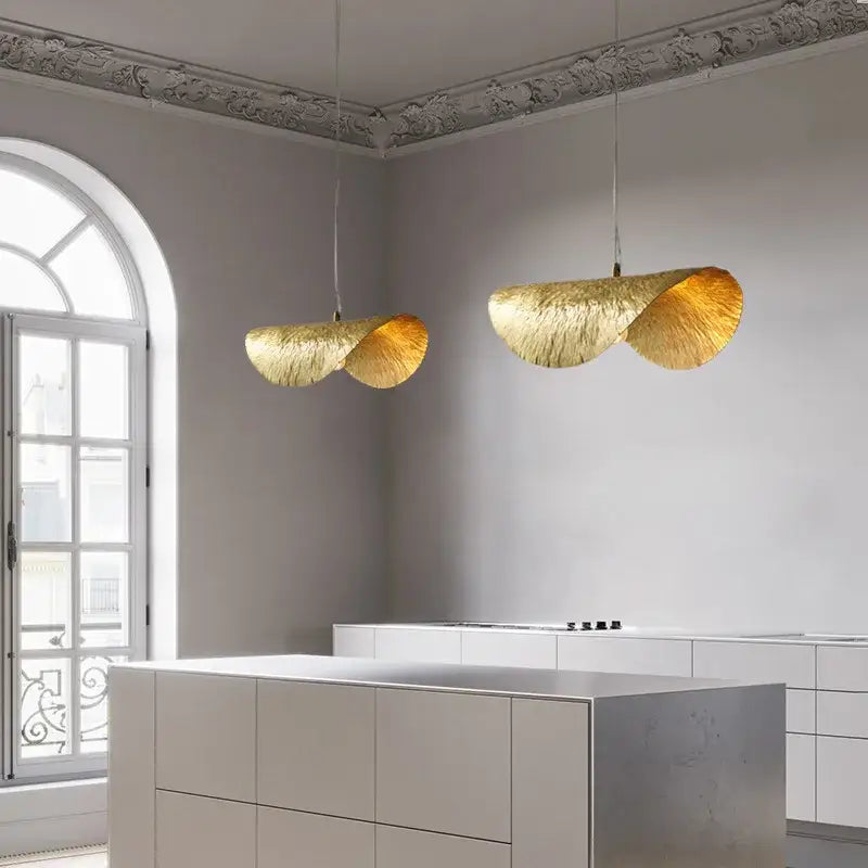 Two elegant golden brass lotus leaf pendant lights with textured finish hang in dining room decorbites brass lotus chandelier