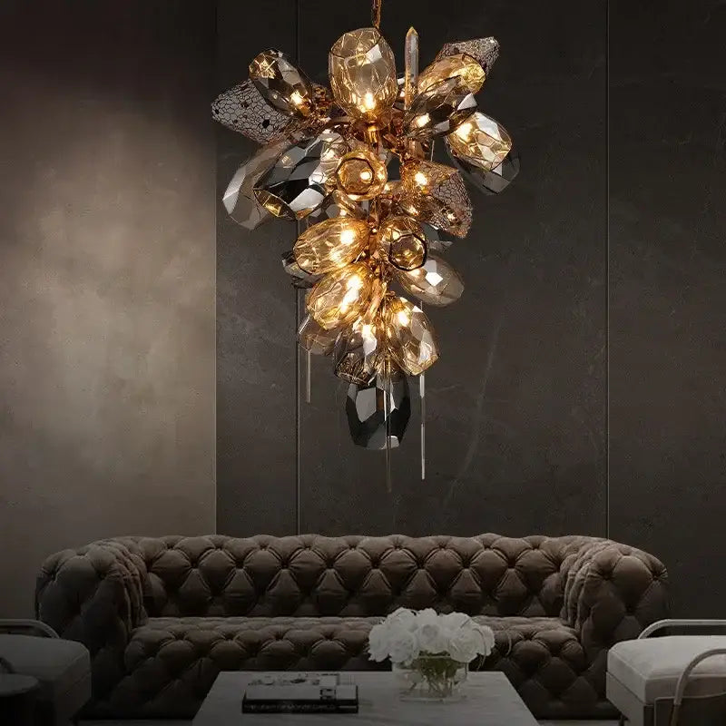A luxurious gold-toned pendant light with sculptural glass shades and crystal droplets for dining room elegance