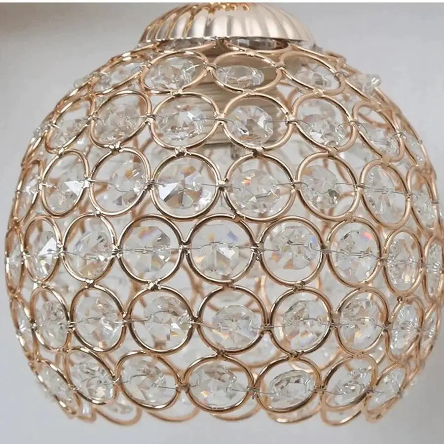 Sculptural gold violinist crystal wall lamp with rose gold frame and clear faceted beads for elegant living room decor