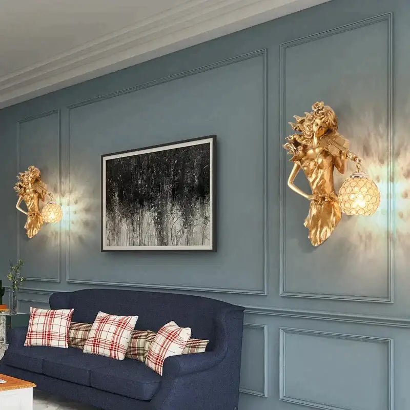 Sculptural gold wall lamp featuring a violinist with flowing hair and a crystal faceted globe lampshade for living room