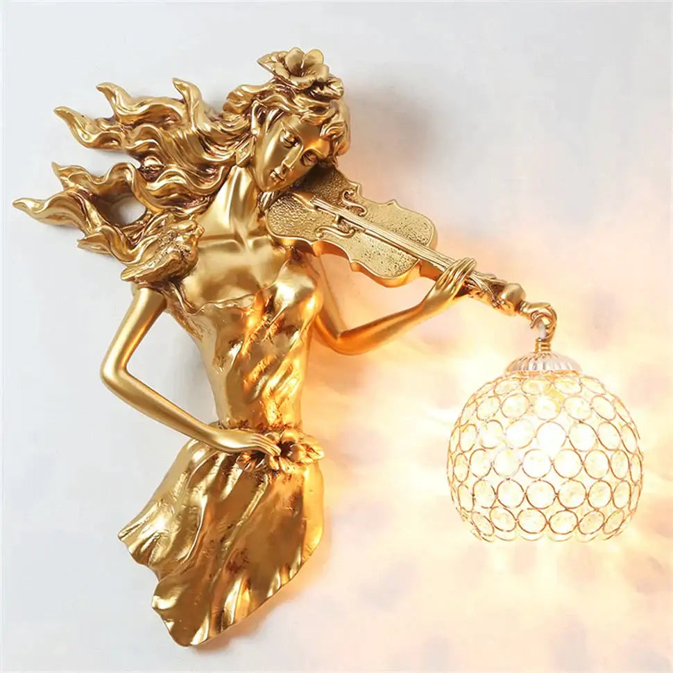 Sculptural gold wall lamp featuring a violinist with flowing hair and an ornate crystal globe crystal wall lamp shade