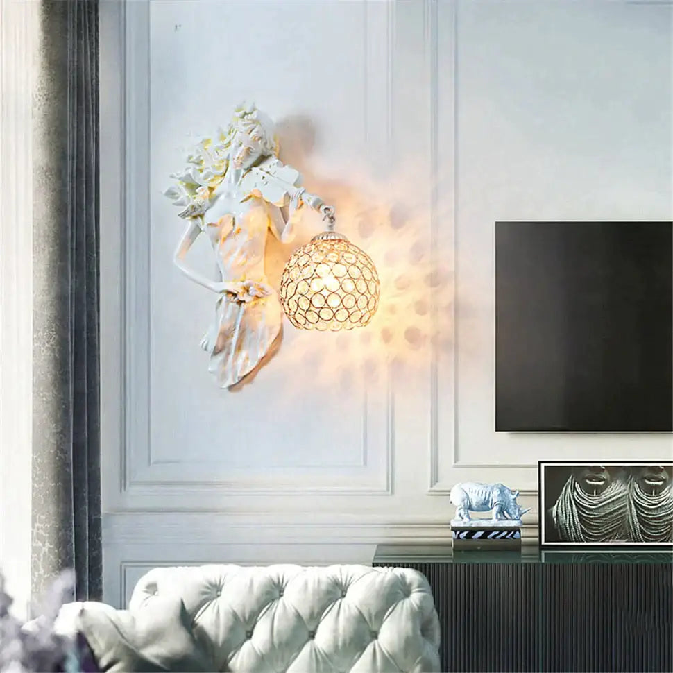 White sculpted wall lamp featuring a classical figure holding an ornate spherical crystal wall lampshade for living room