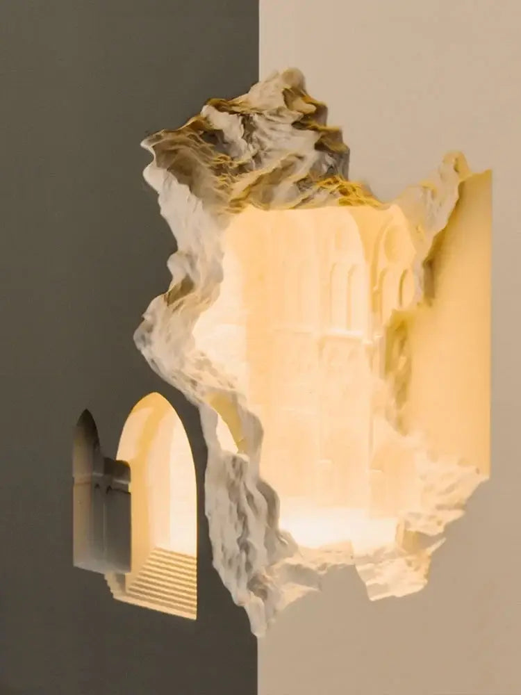 Sculptural stone embedded night light wall sconces in creamy white and gold with textured marble finish and warm lighting