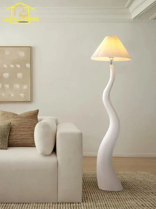 Sculptural white floor lamp with pleated beige shade made of decorbites cream resin for elegant living room lighting