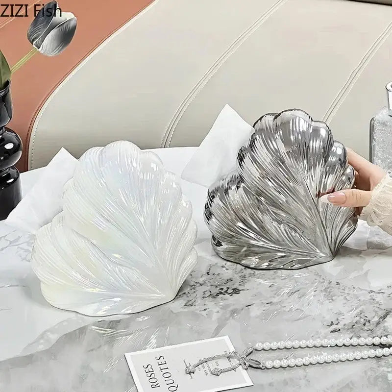 A sleek metallic silver seashell tissue box with glossy ridged detailing for decorbites heart feather ceramic decor