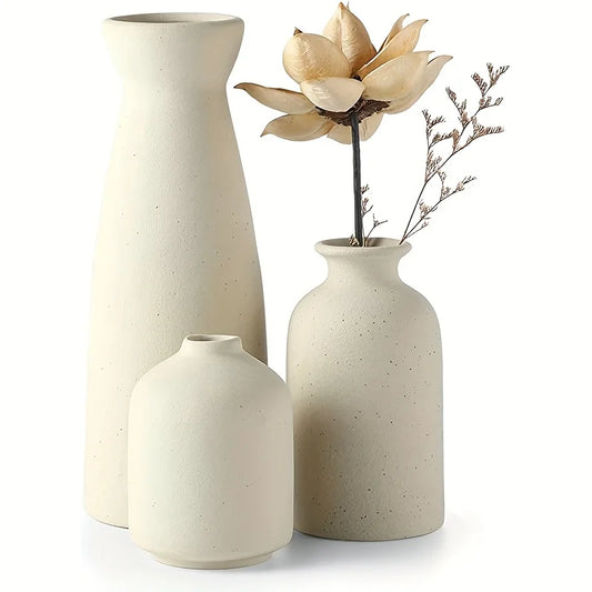 Set of three cream-colored speckled ceramic vases with minimalist modern shapes for rustic and farmhouse decor