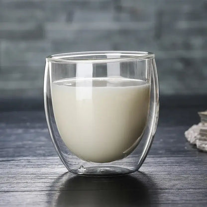 Set of 3 clear double wall glass cup tumblers with creamy white liquid for kitchen and dining use