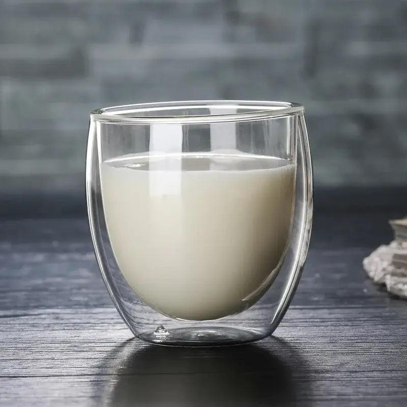 Set of 3 clear double wall glass cup tumblers with creamy white liquid for kitchen and dining use