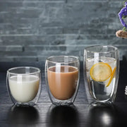 Set of 3 clear double wall glass cup tumblers filled with different beverages for kitchen and dining use